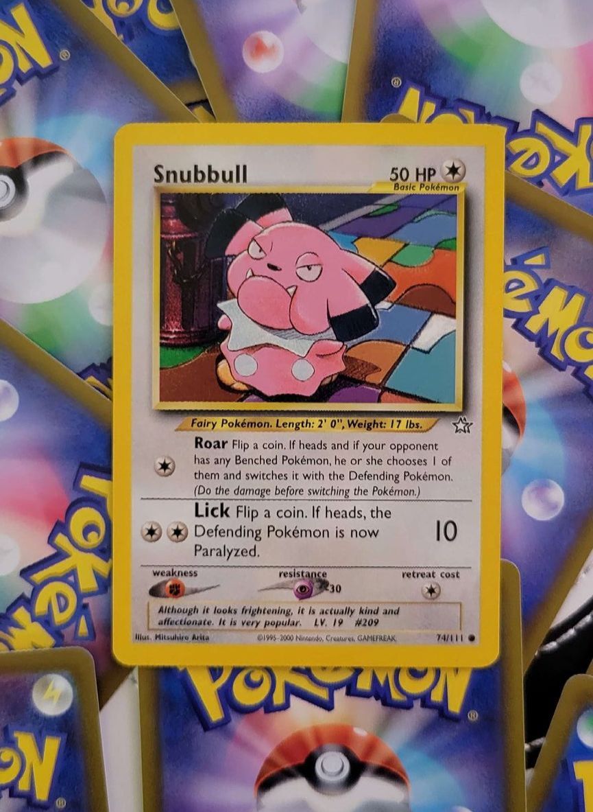 a stack of Pokémon cards one of which is snubbbull