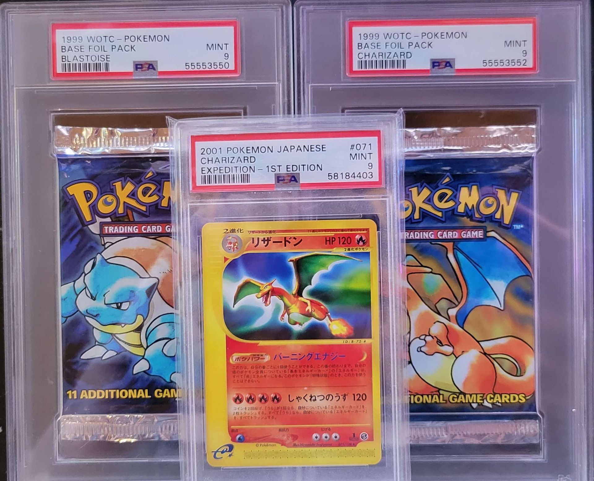 two base set pokemon vintage booster packs and a graded charizard pokemon card
