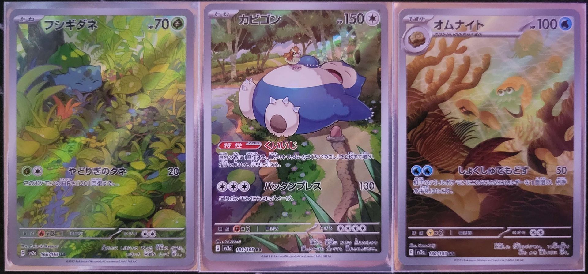 three different alternative art pokemon cards in a row