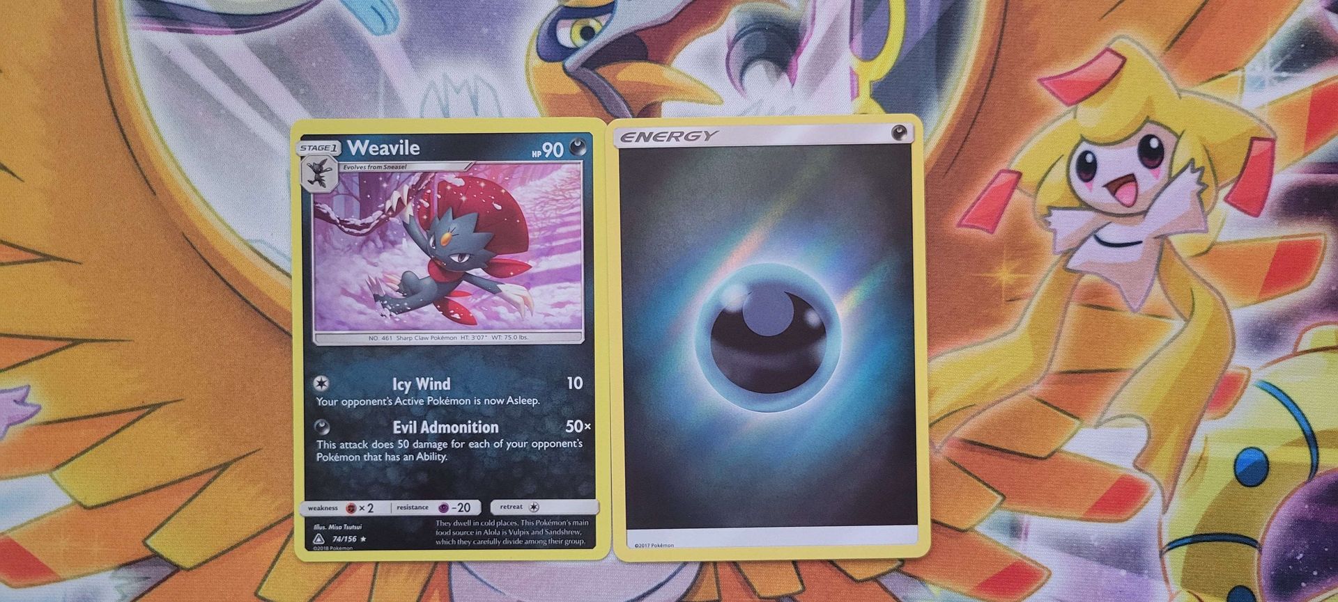 A Dark-type Pokémon beside a Dark Energy card.