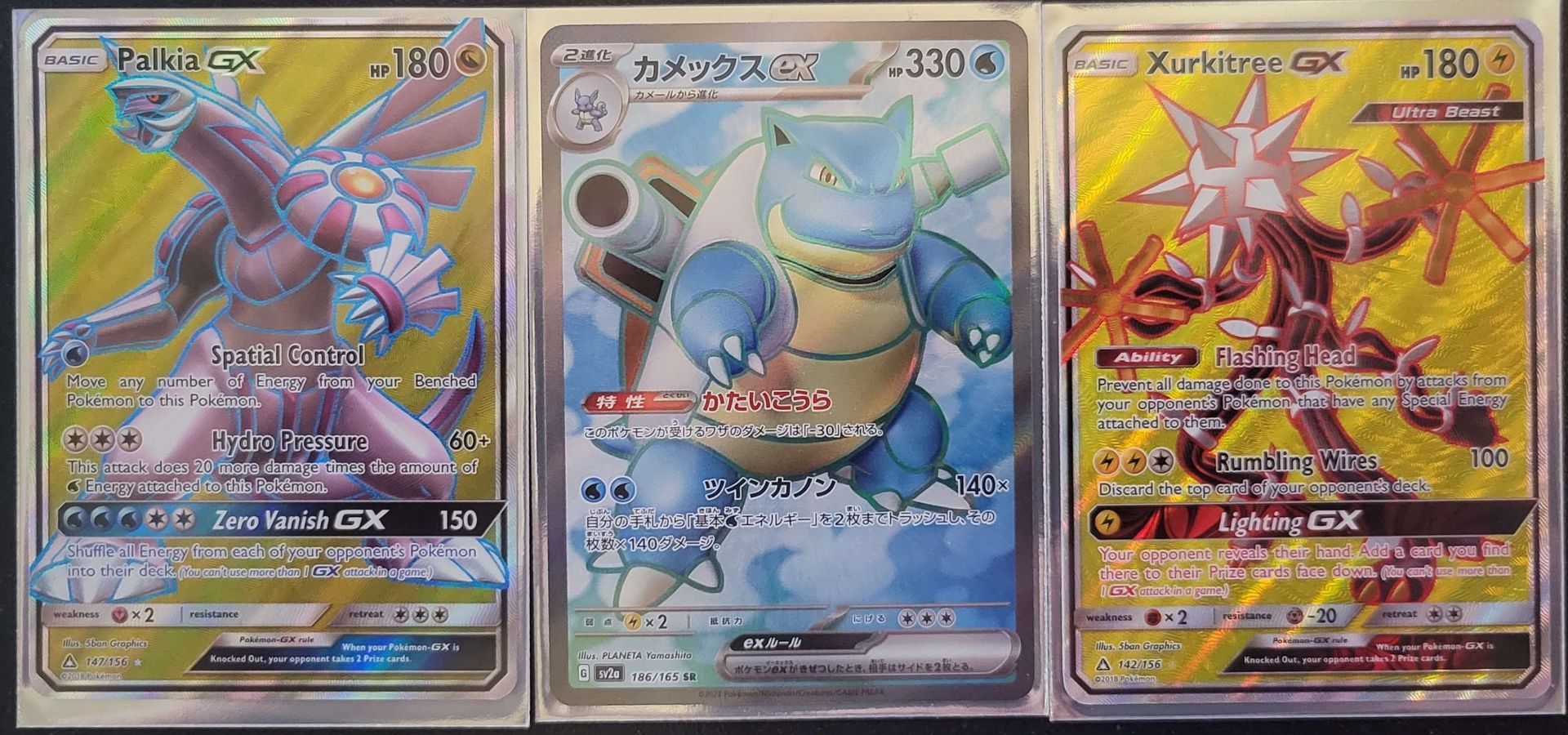 three full art Pokémon cards in a row