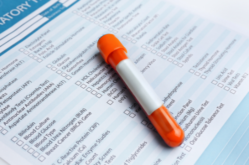 A test tube is sitting on top of a medical form.