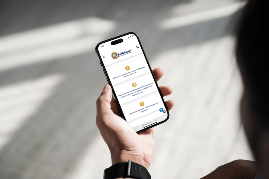 Person holding a phone displaying Your LabRetriever website