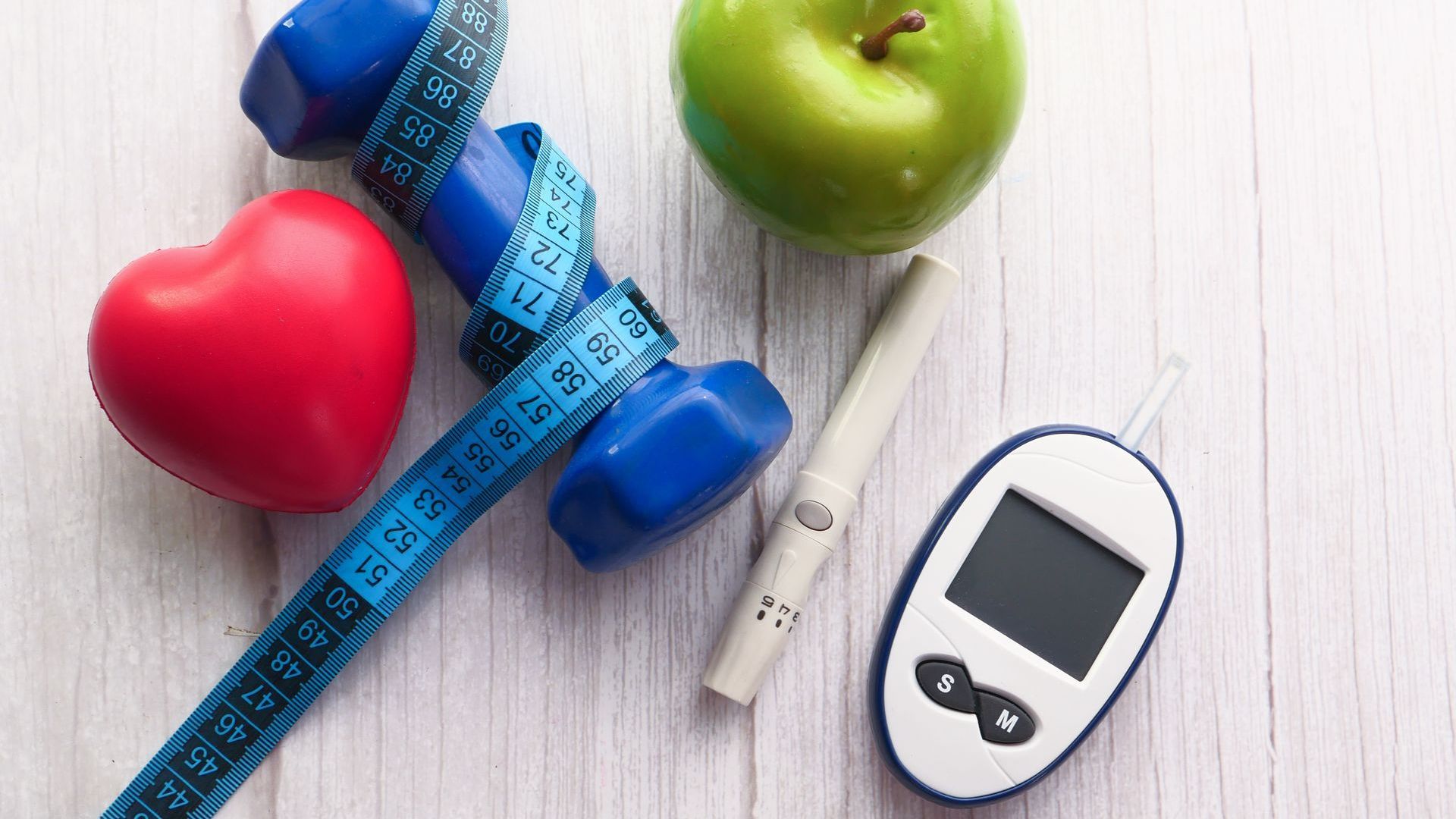 blood sugar measurement kits, with dumbbell and apple on a table | lab work done at home Miami Florida