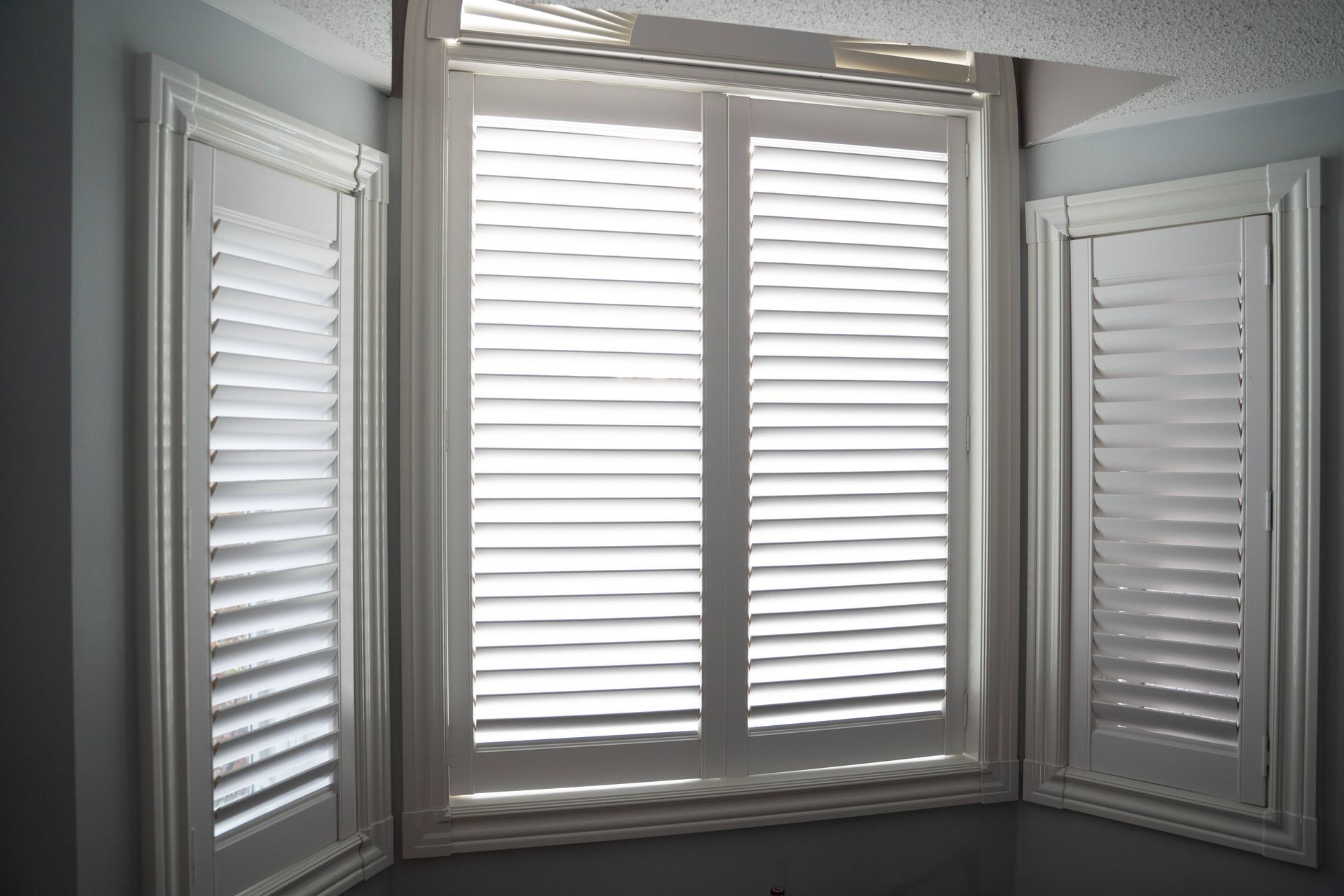 White shutters covering a window in a home near Manchester, NH