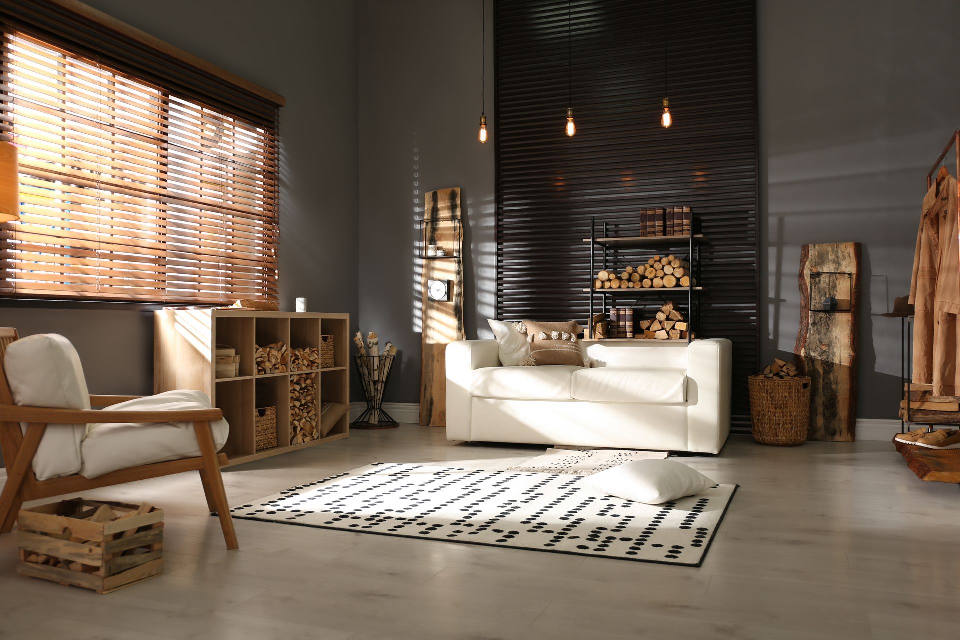 Rustic living room with furniture, stacked firewood, and wood blinds.