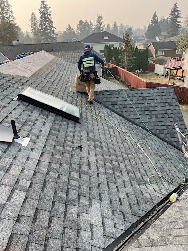 A man is standing on top of a roof.