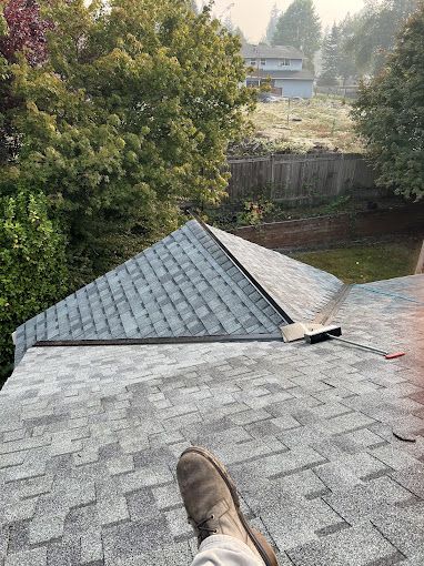 A person is sitting on top of a roof.