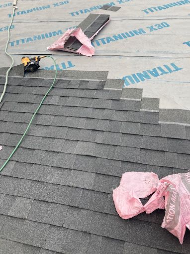 A roof is being installed with shingles and insulation.