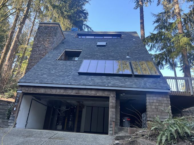 A house with a garage and solar panels on the roof.