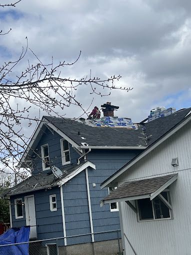 A man is working on the roof of a house.