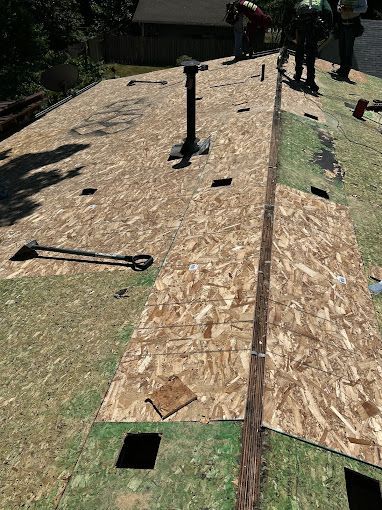 A group of people are working on a roof.