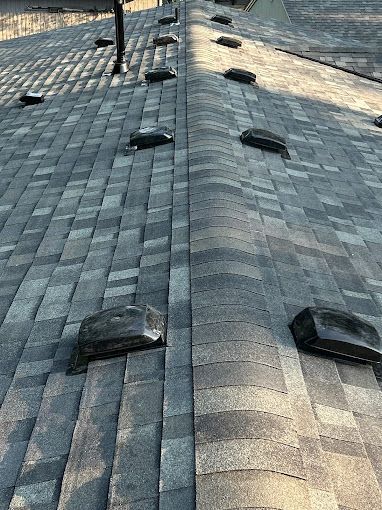 A close up of a roof with a lot of shingles on it.