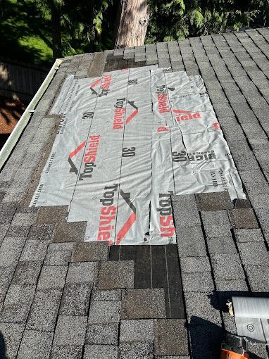 A roof with shingles being installed on it.