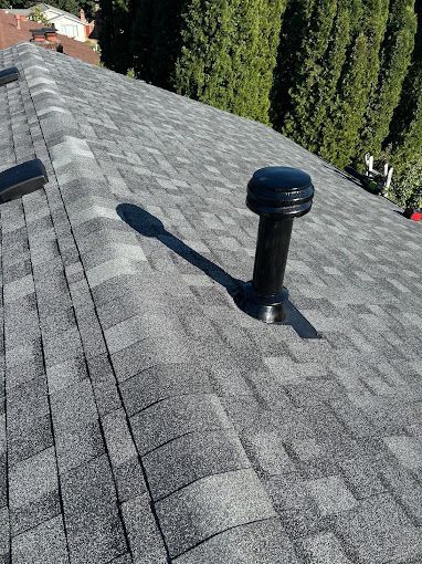 A close up of a roof with a vent on it.