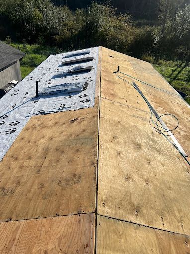A roof with a lot of plywood on it is being repaired.