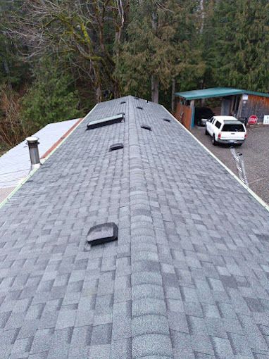A roof with a lot of shingles and a car parked on it.