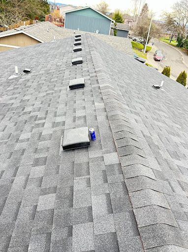 A close up of a roof with a row of vents on it.