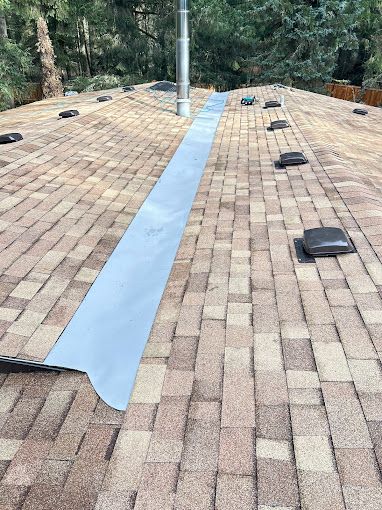 A brick roof with a chimney on top of it.
