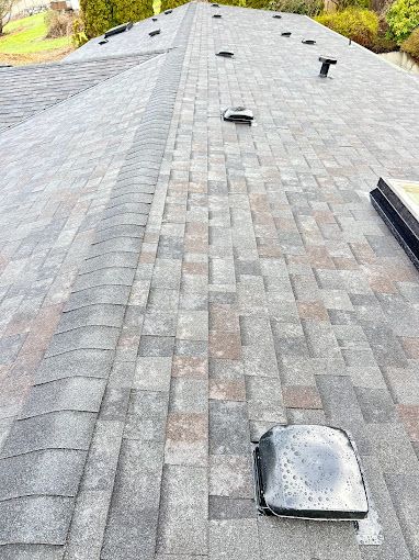 A close up of a roof with a lot of shingles on it.