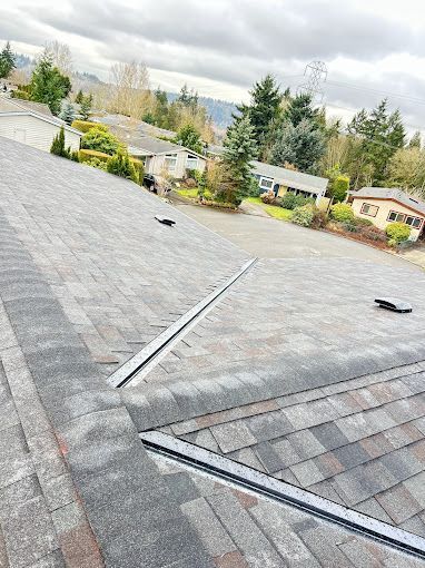 A close up of a roof with a solar panel on it.