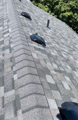 A close up of a roof with a few vents on it.