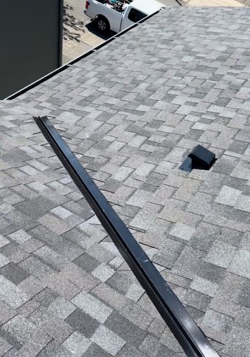 A white truck is parked on the roof of a building.