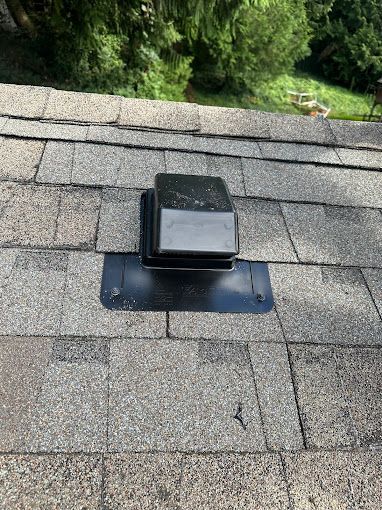 There is a roof vent on the roof of a house.