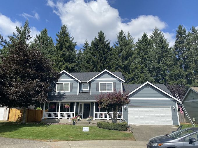 A large house with a car parked in front of it
