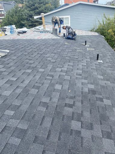 A man is working on the roof of a house.