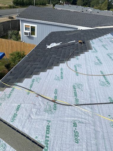 A roof is being installed on a house.
