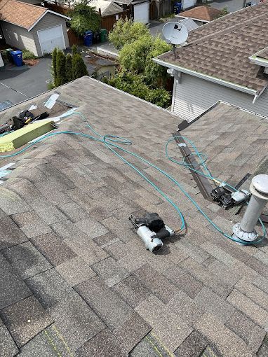 A roof with a hose attached to it is being repaired.