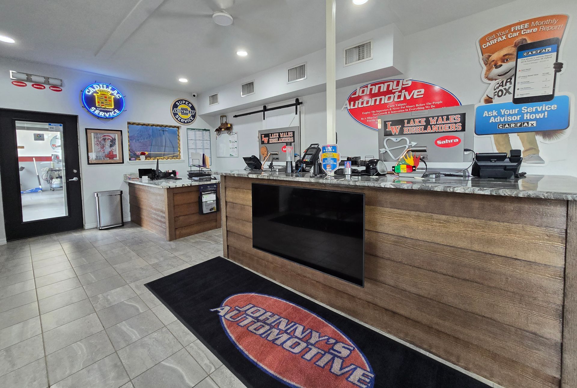 Interior of Johnny's Automotive: A reception area with a counter, waiting area, and advertising on the walls. | Johnny's Automotive