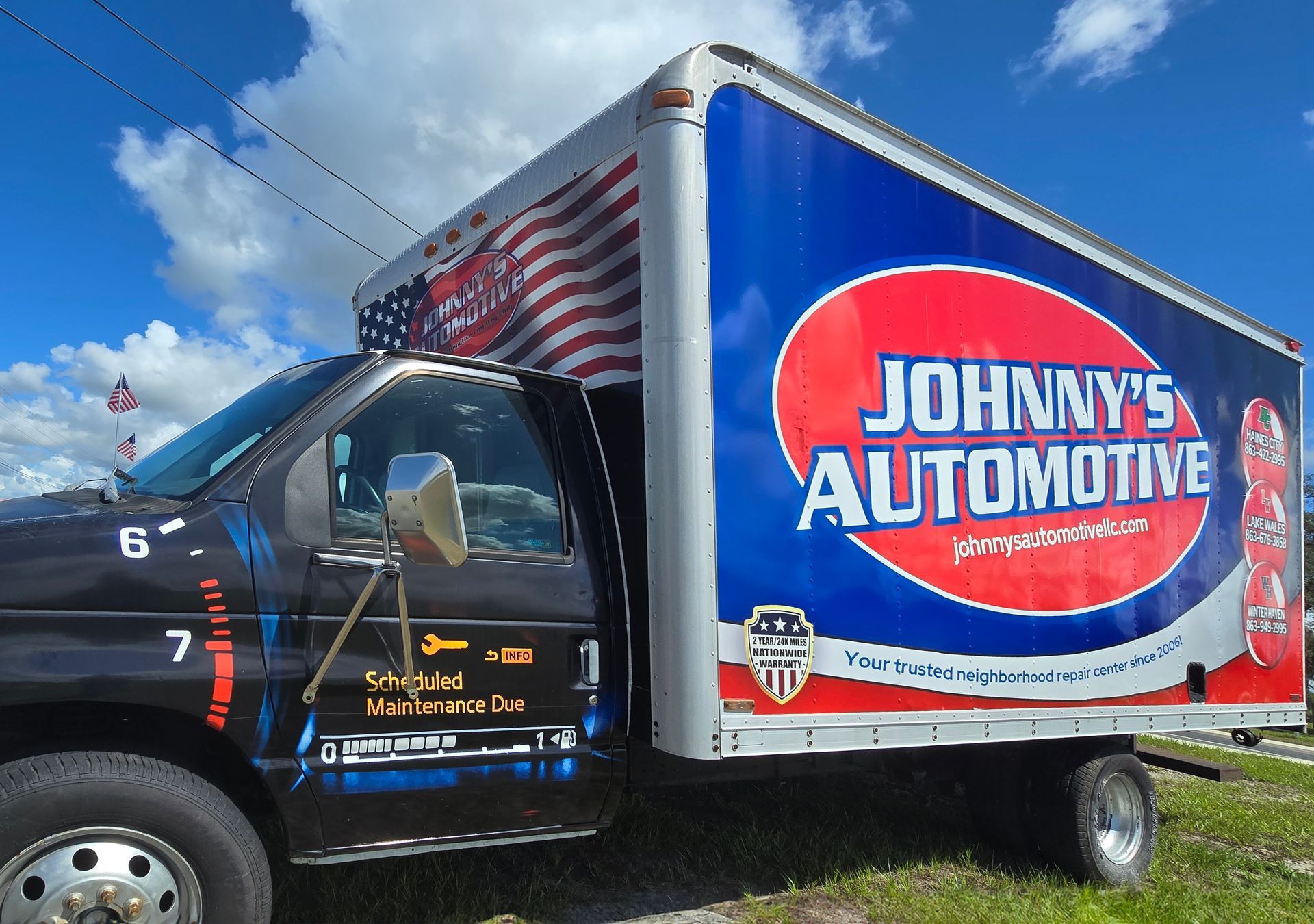 Johnny's Automotive box truck with an American flag on the top. | Johnny's Automotive