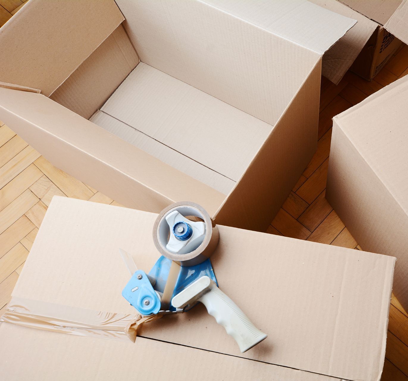 A tape dispenser is sitting on top of a cardboard box