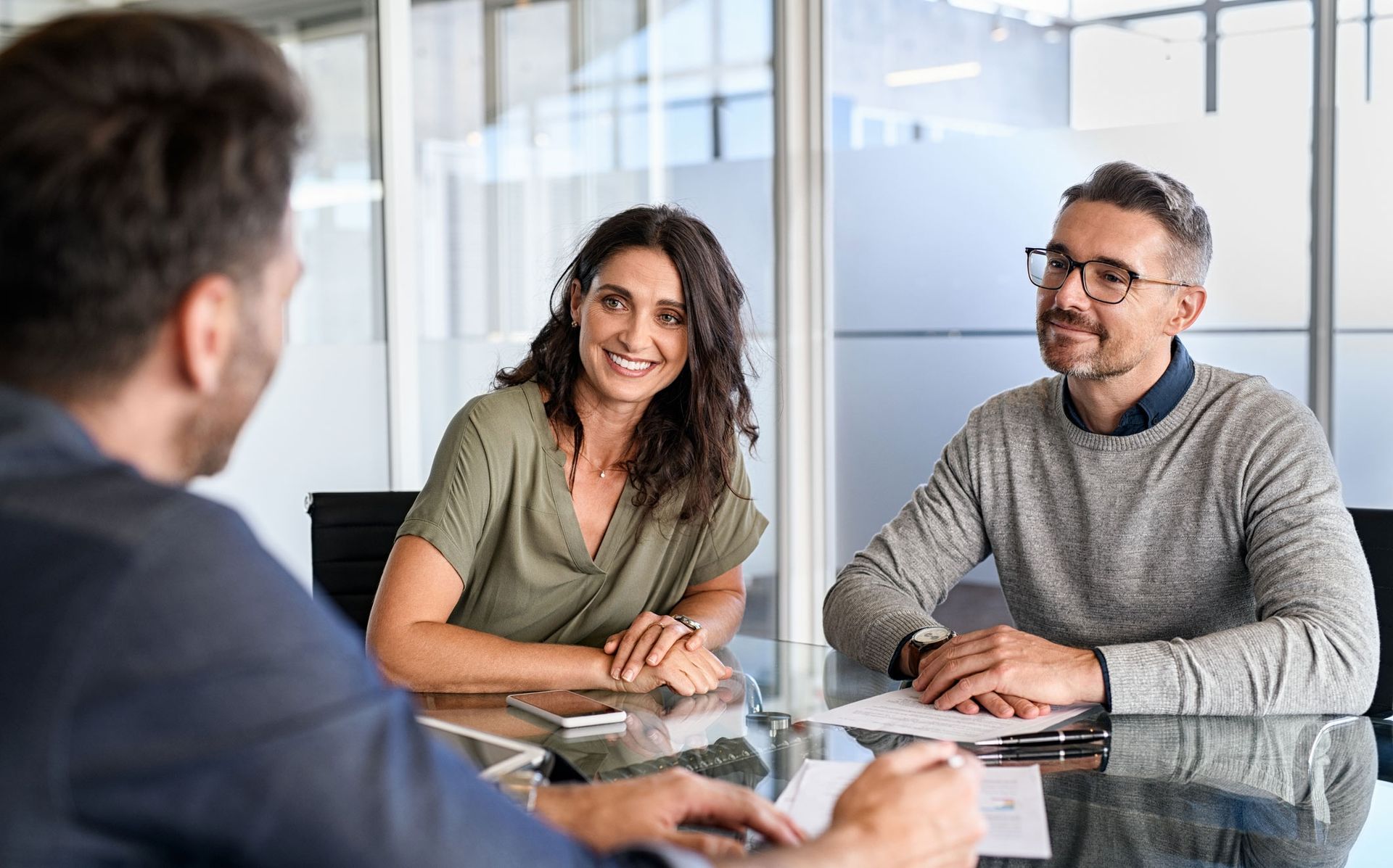 A man and a woman are sitting at a table having a meeting.