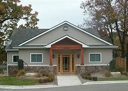 A large house with a lot of windows and a porch.
