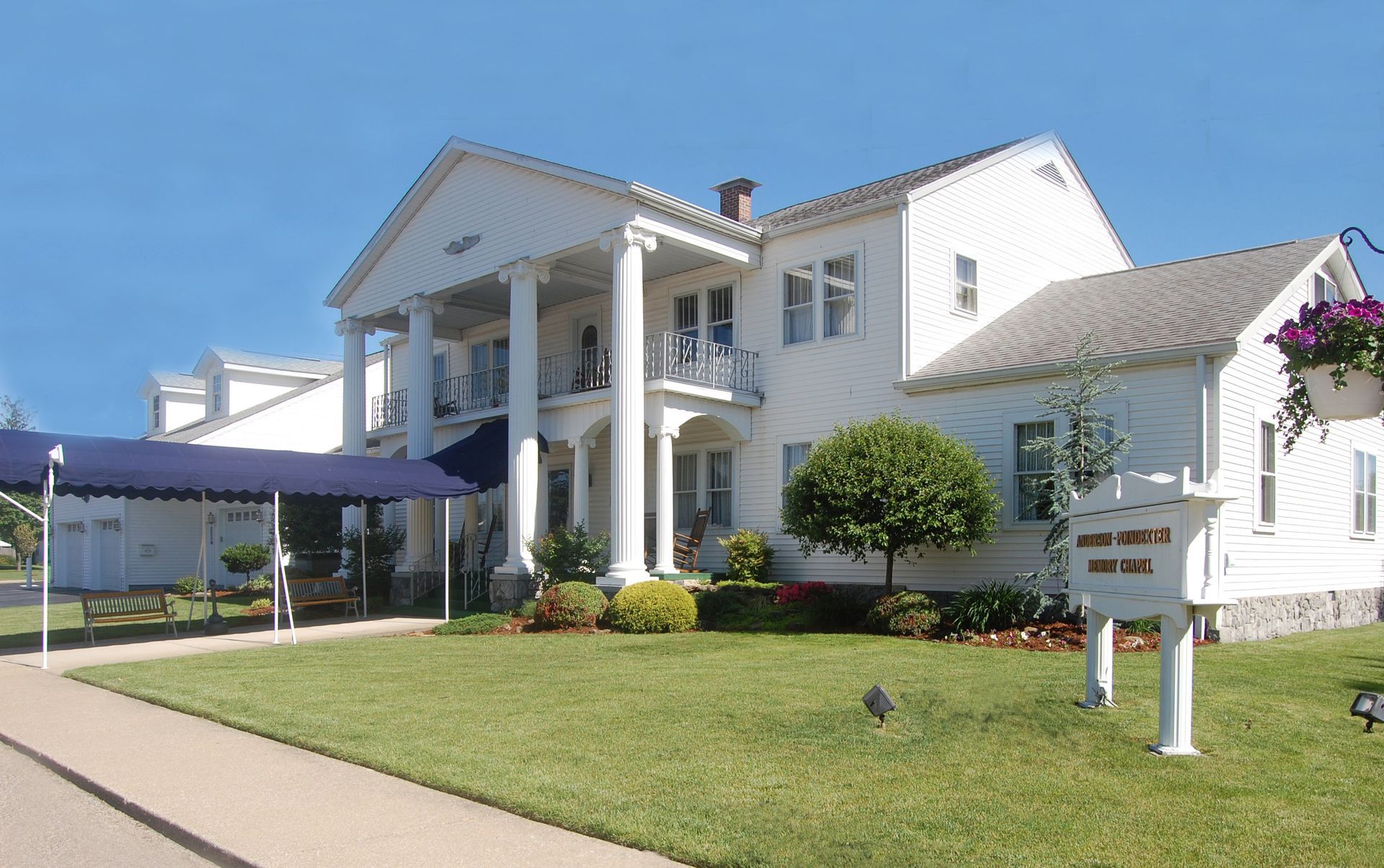White house with columns, a sign that says 