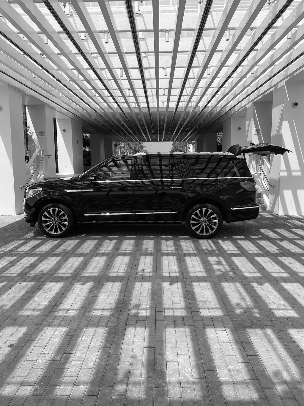 A black and white photo of a car parked in a tunnel.