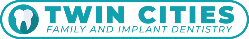 Logo of Twin Cities Family and Implant Dentistry with a tooth icon.