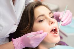 Teeth being polished by a dental tool; clean and shiny with blue sparkles.