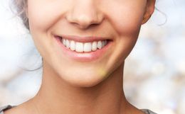Healthy white teeth in pink gums.