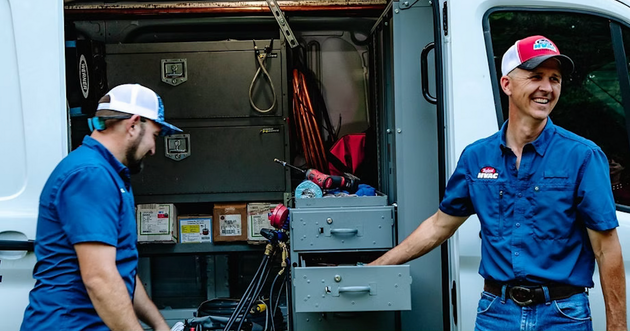 A group of men are posing for a picture together