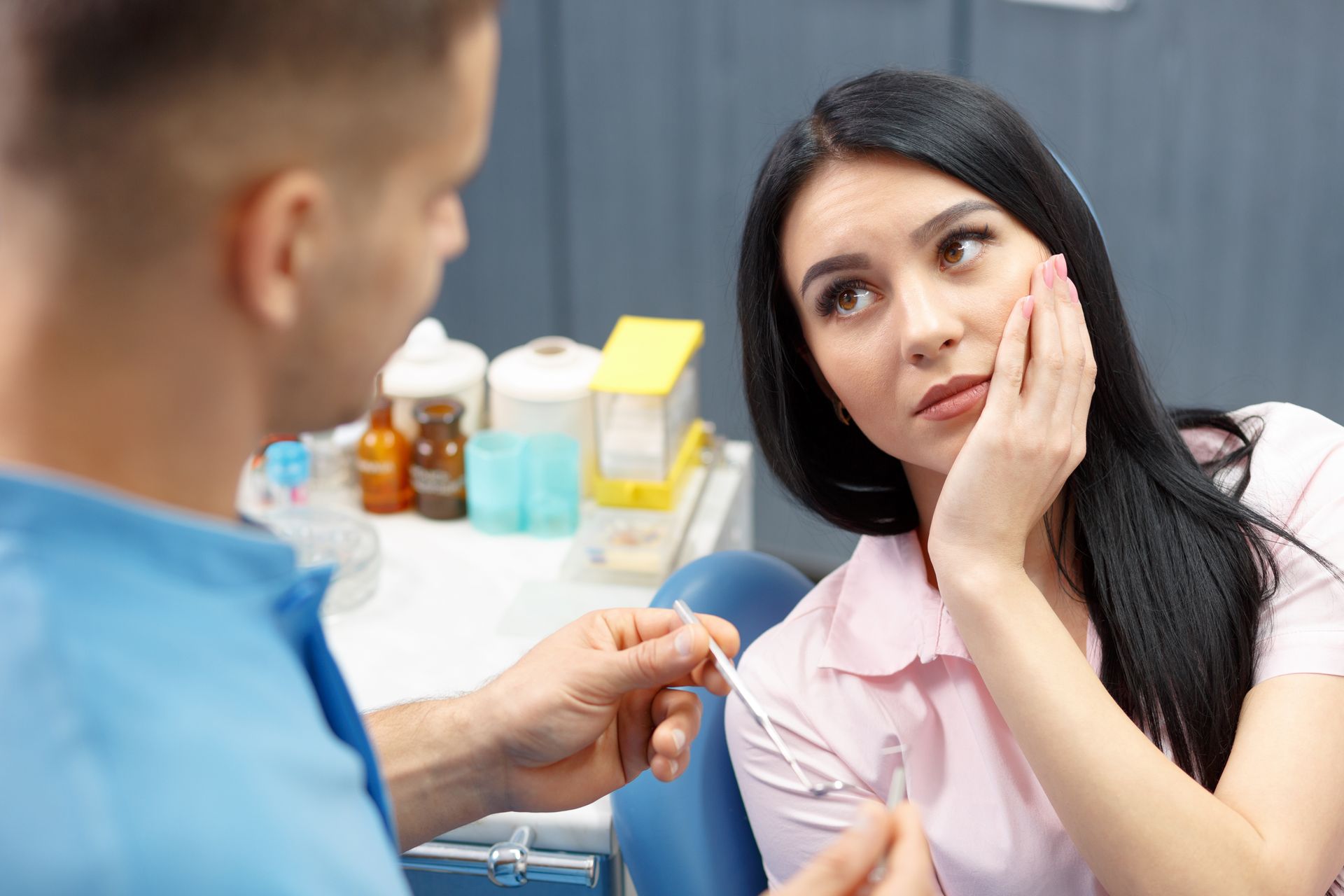 A dentist explaining root canal treatment to a patient.
