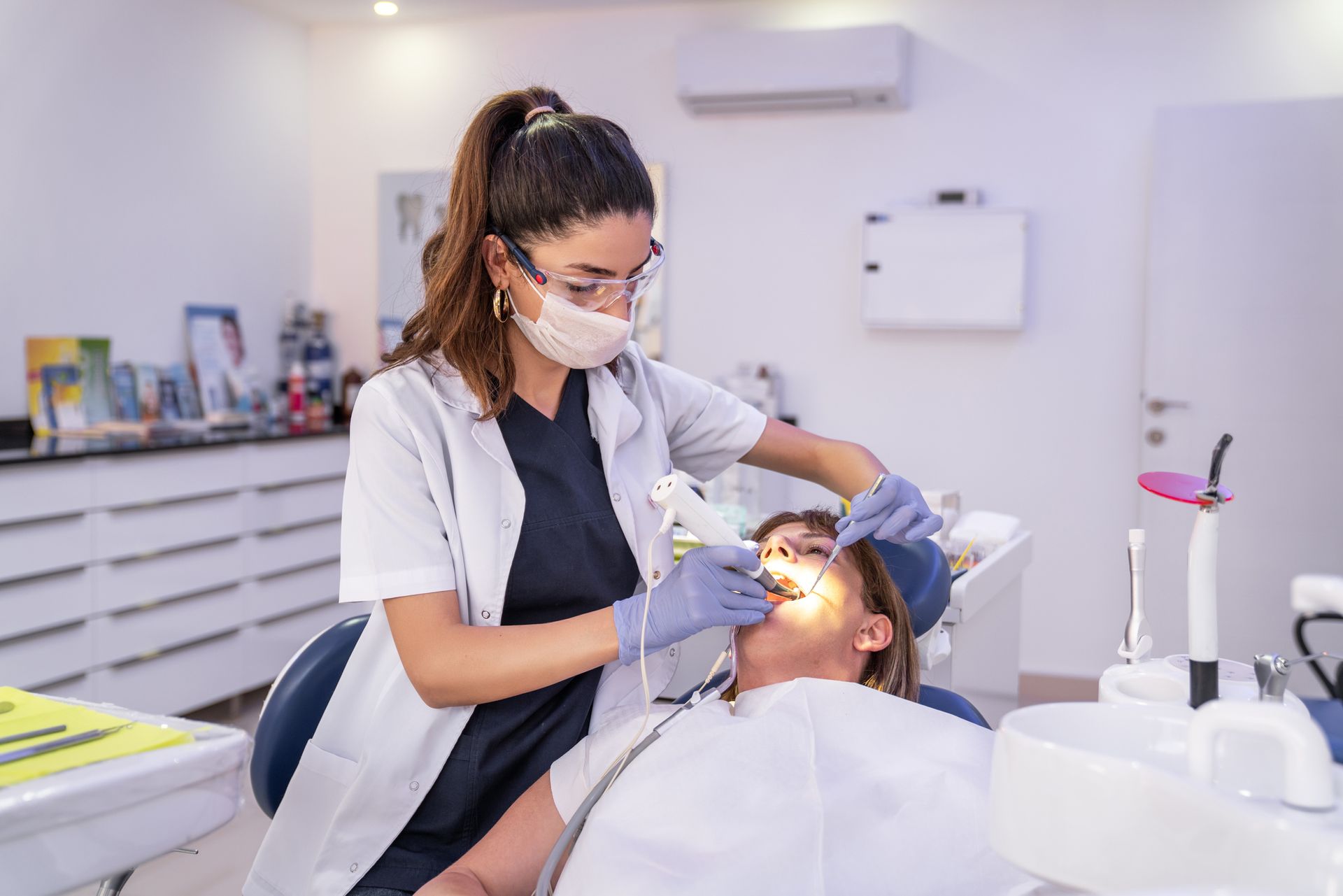 A woman is getting dental treatment in a dental clinic.