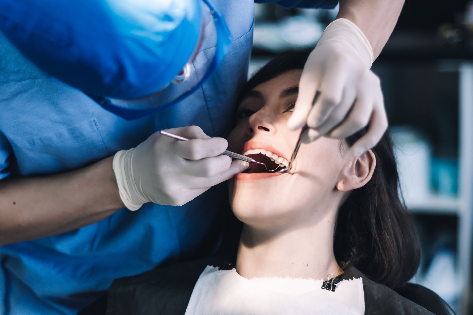 Female patient being treated by a dentist at a dental clinic.