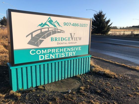 Sign for BridgeView Dental Group, with teal and white branding, mountain and bridge graphic, and phone number.