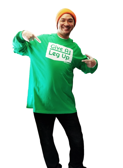 A man wearing a green t-shirt that says give all leg up