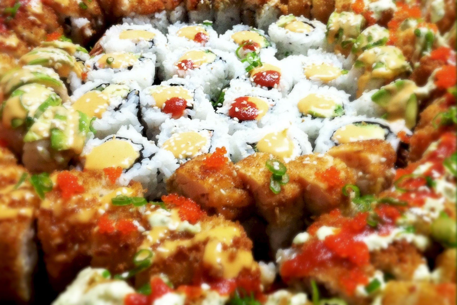 There are many different types of sushi on the table.