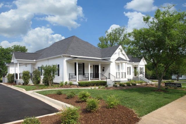 A large office building with a lot of windows on a sunny day.